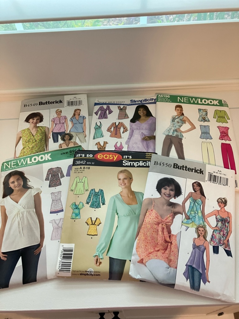 Six uncut sewing patterns, women’s blouses sizes 6–18